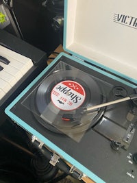 a blue record player with a keyboard in it